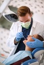 Dentist checking up womanÃ¢â¬â¢s teeth